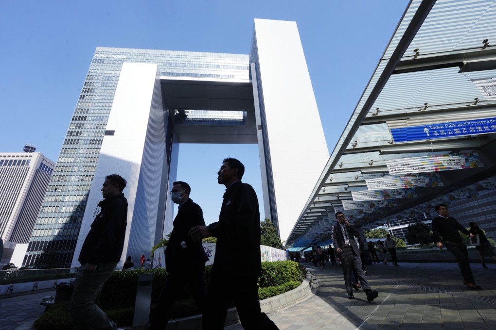 Civil servants leave the government’s headquarters at Tamar, Admiralty, on December 17. The freeze on civil service pay has reignited the discussion about public-sector compensation. Photo: Sun Yeung