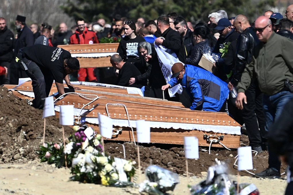Coffins are laid side by side during a funeral on Thursday for victims of the March 16 nightclub fire in North Macedonia. Photo: AFP