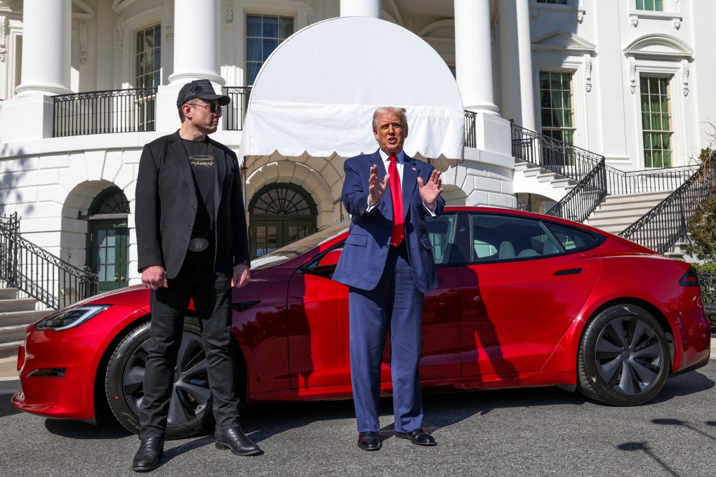 U.S. President Donald Trump talks to the media while standing next to Tesla CEO Elon Musk, with a Tesla car in the background, at the White House in Washington on March 11. Photo: Reuters