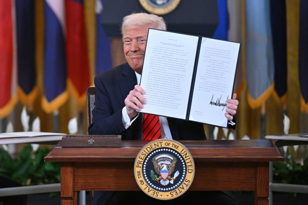 US President Donald Trump holds up an executive order after signing it during an education event at the White house in Washington on Thursday. Photo: AFP