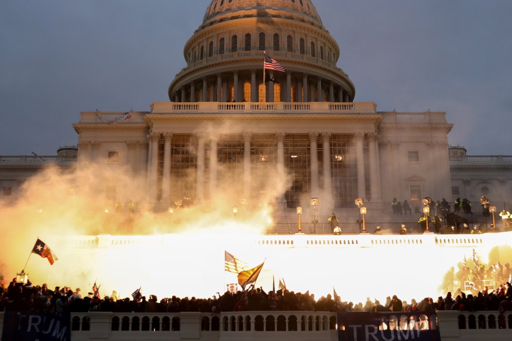 An explosion caused by a police munition is seen while supporters of US President Donald Trump riot in front of the US Capitol Building in Washington, on January 6, 2021. Photo: Reuters