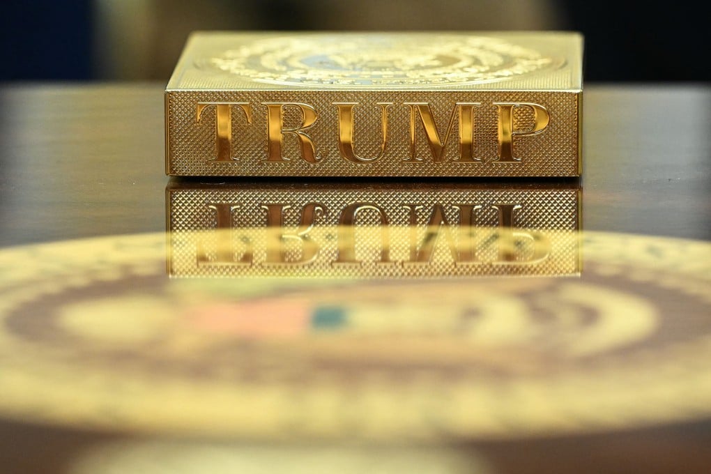 A gold coaster reading “TRUMP” sits on a table in the Oval Office of the White House in Washington. Photo: AFP / Getty Images / TNS
