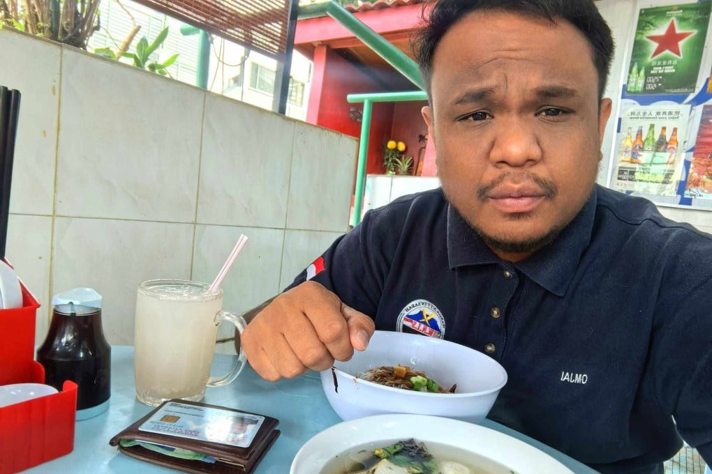 Verdi Kornelis Omjai posts a photo of himself eating with his identity card on the table to prove he isn’t Malay on social media. Photo: Facebook/Verdi Kornelis Omjai