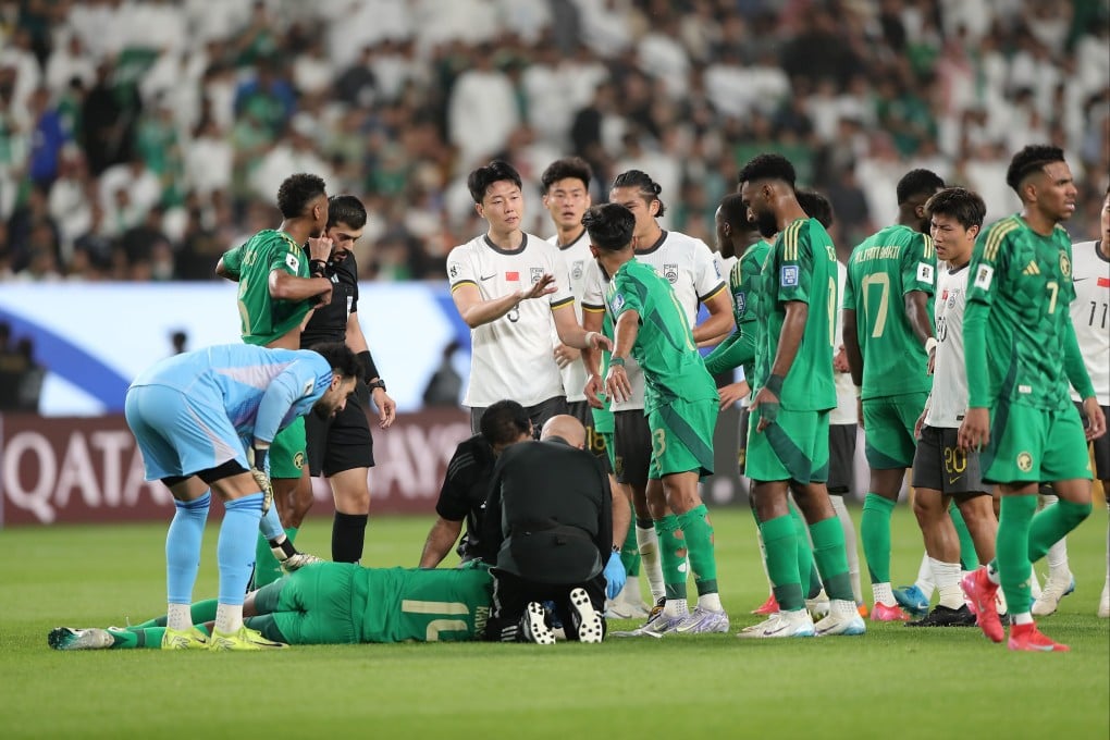 Players from China and Saudi Arabia gather around the injured Hassan Kadesh (bottom), who was fouled by Lin Liangming, during their 2026 Fifa World Cup qualifier. Photo: Xinhua