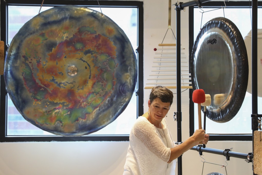 Martha Collard strikes a gong at Red Doors Studio in Wong Chuk Hang, Hong Kong, which she opened in 2015 after nearly three decades in corporate work. Photo: Nora Tam
