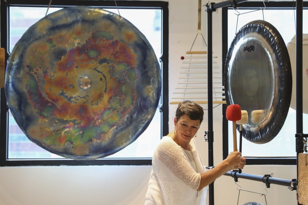 Martha Collard strikes a gong at Red Doors Studio in Wong Chuk Hang, Hong Kong, which she opened in 2015 after nearly three decades in corporate work. Photo: Nora Tam