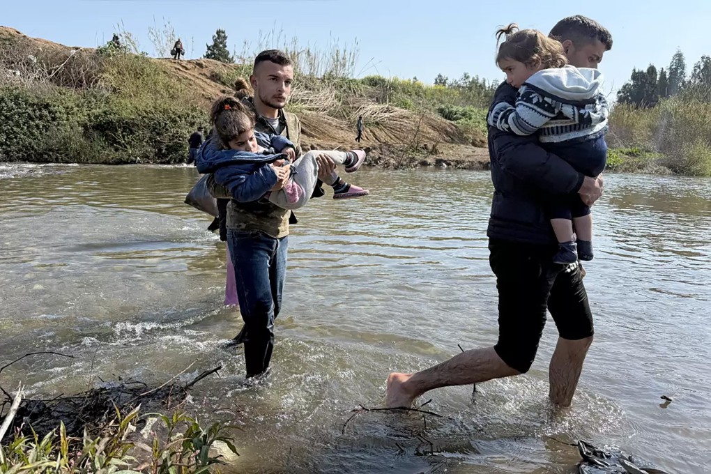 Syrians crossing the Kabir River, from Syria into north Lebanon, on March 12. Photo: TNS