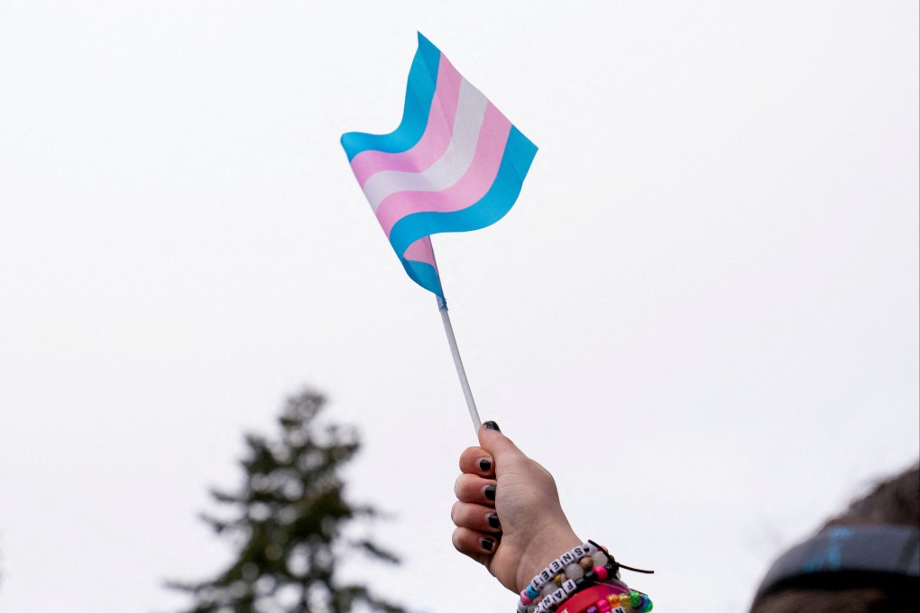 A demonstrator holds a trans flag during a rally in Seattle, Washington,  in February. Photo: Reuters