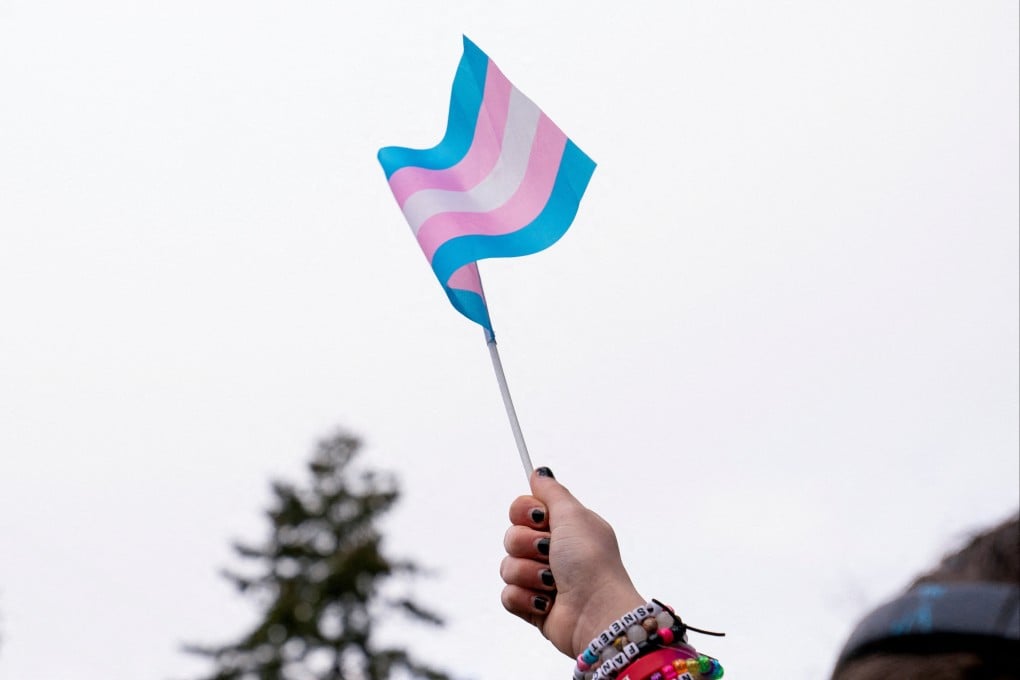 A demonstrator holds a trans flag during a rally in Seattle, Washington, in February. Photo: Reuters
