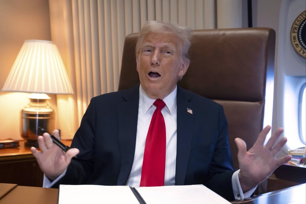 President Donald Trump speaks to reporters aboard Air Force One. Photo: AP