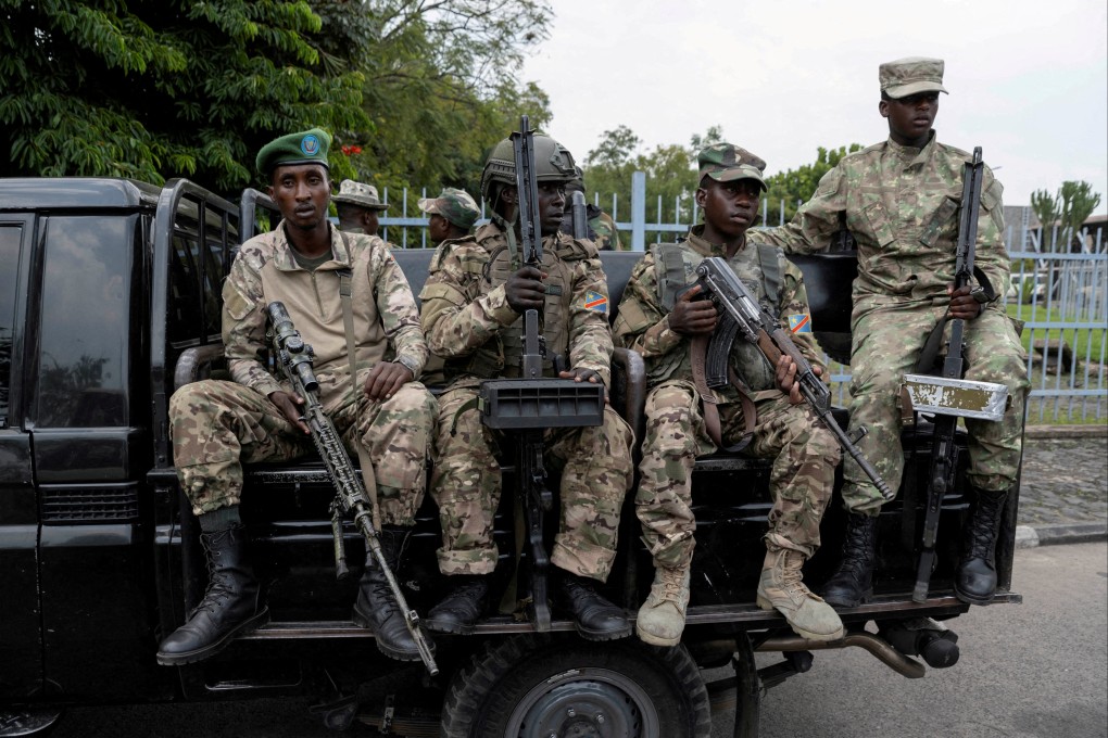 M23 rebels sit on a truck during the escort of captured FDLR members (not pictured) to Rwanda for repatriation, at the Goma-Gisenyi Grande Barrier border crossing, on March 1. Photo: Reuters