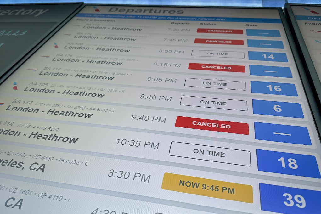 Cancellations for British Airways flights to London Heathrow Airport are displayed as cancelled on a departures board at JFK International airport on Friday, March 21 in New York. Photo: AP