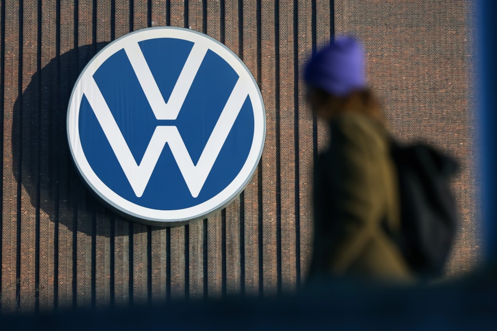 A person walks next to the logo of German car maker Volkswagen on a wall at the company’s plant in Wolfsburg, Germany, on March 7. Photo: EPA-EFE