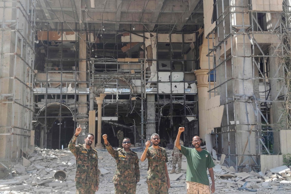 Soldiers pose for a picture at the damaged presidential palace after the Sudanese army recaptured the complex from RSF troops in Khartoum on Friday. Photo: AFP