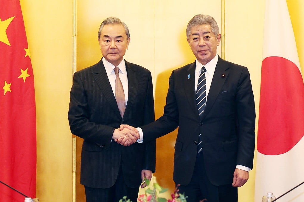 Chinese Foreign Minister Wang Yi shakes hands with Japanese Foreign Minister Takeshi Iwaya in Tokyo on Saturday. Photo: Xinhua