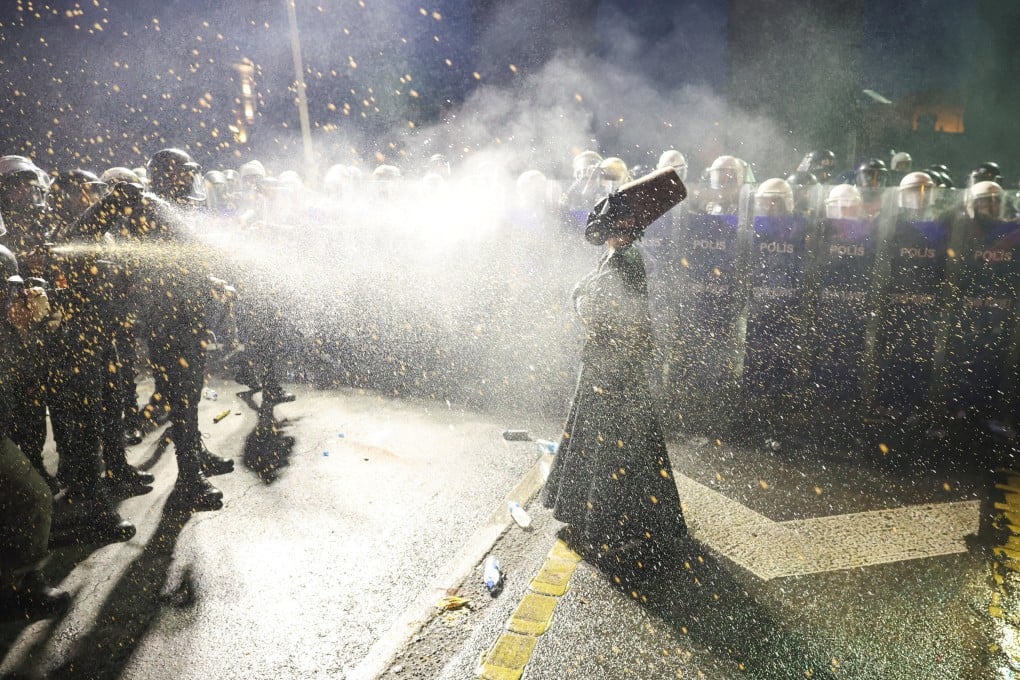 Police officers use pepper spray on a demonstrator during a protest in Istanbul on the day Ekrem Imamoglu was jailed. Photo: Reuters