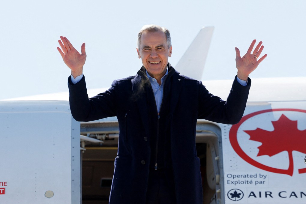 Canada’s Prime Minister Mark Carney gestures, as he boards an aircraft, after calling for an election, in Ottawa, Ontario, Canada March 23, 2025.  REUTERS/Blair Gable
