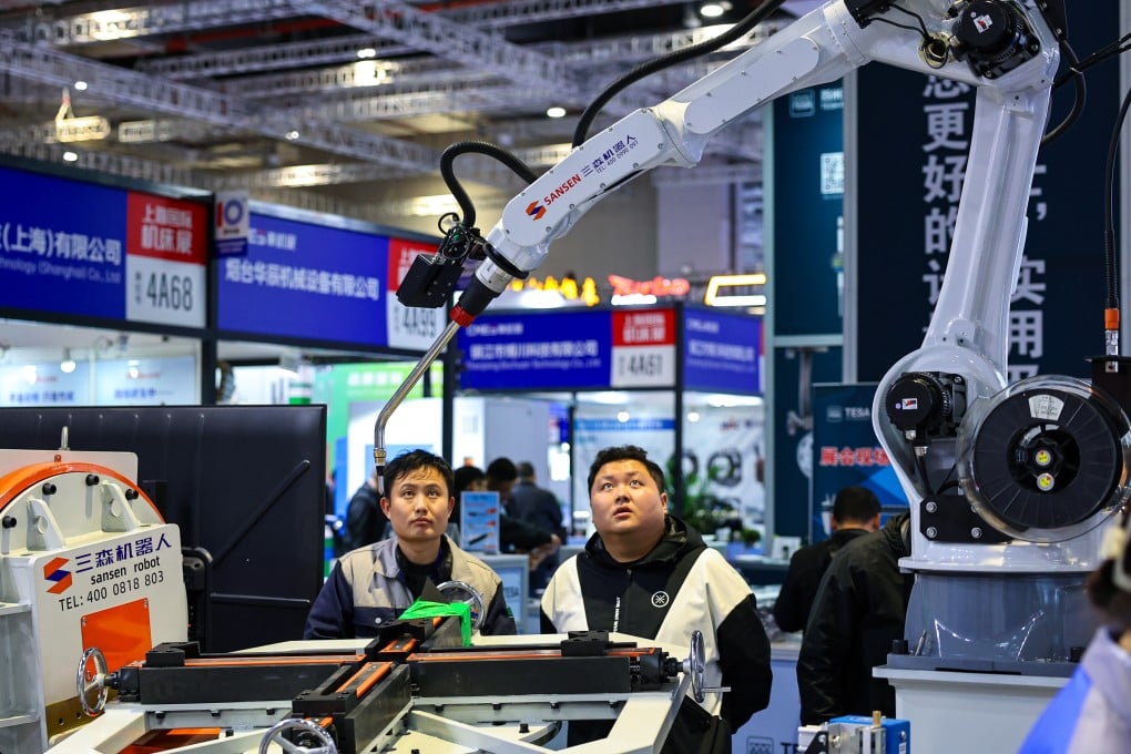 Visitors watch a robot demonstration during the Shanghai International Machine Tool Exhibition in Shanghai on March 3. China is hanging some hopes for GDP growth on technological advancements. Photo: Xinhua