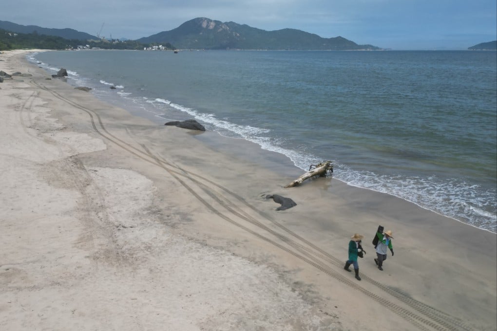 Workers clean Upper Cheung Sha Beach on Lantau island on May 28, 2024. Photo: Eugene Lee