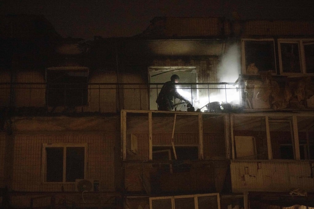 A firefighter eliminates a fire in a damaged residential building following a drone attack in Kyiv, Ukraine. Photo: AFP