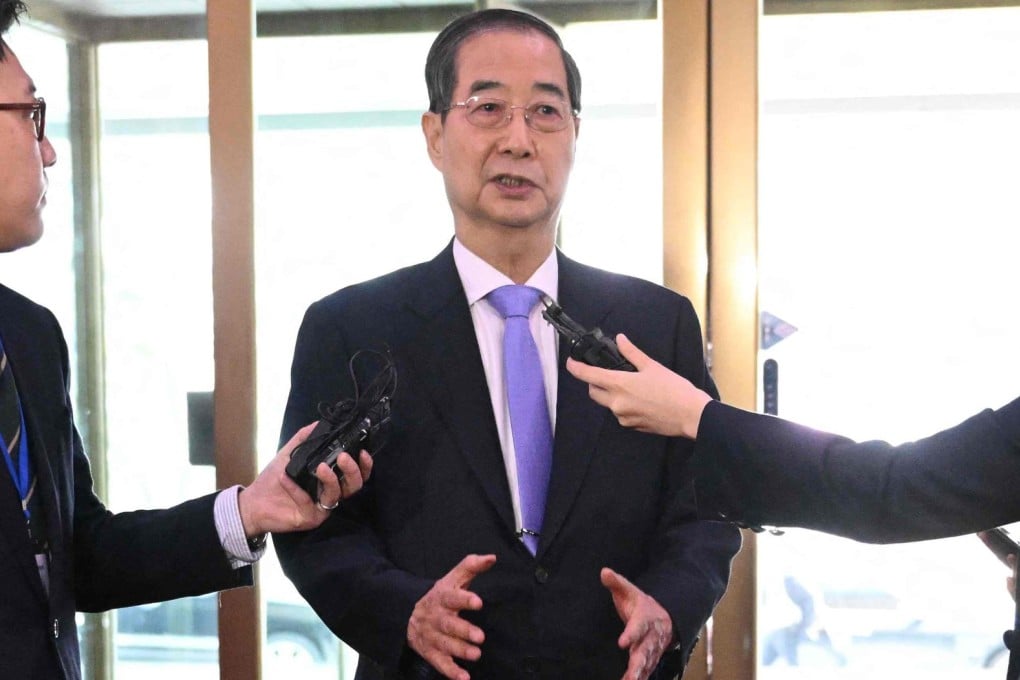 South Korean Prime Minister Han Duck-soo speaks to the media on Monday after being reinstated as acting president. Photo: AFP