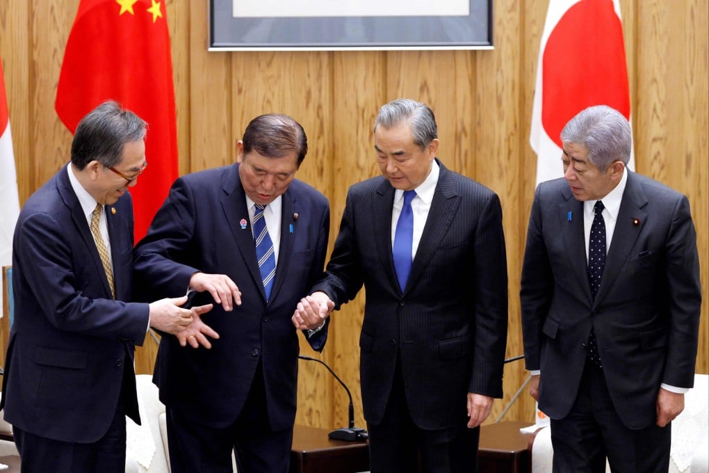 Japanese Prime Minister Shigeru Ishiba (second left) with (from left) foreign ministers Cho Tae-yul of South Korea, Wang Yi of China and Japan’s Takeshi Iwaya, ahead of their meeting at the prime minister’s official residence, in Tokyo on March 21. Photo: AFP
