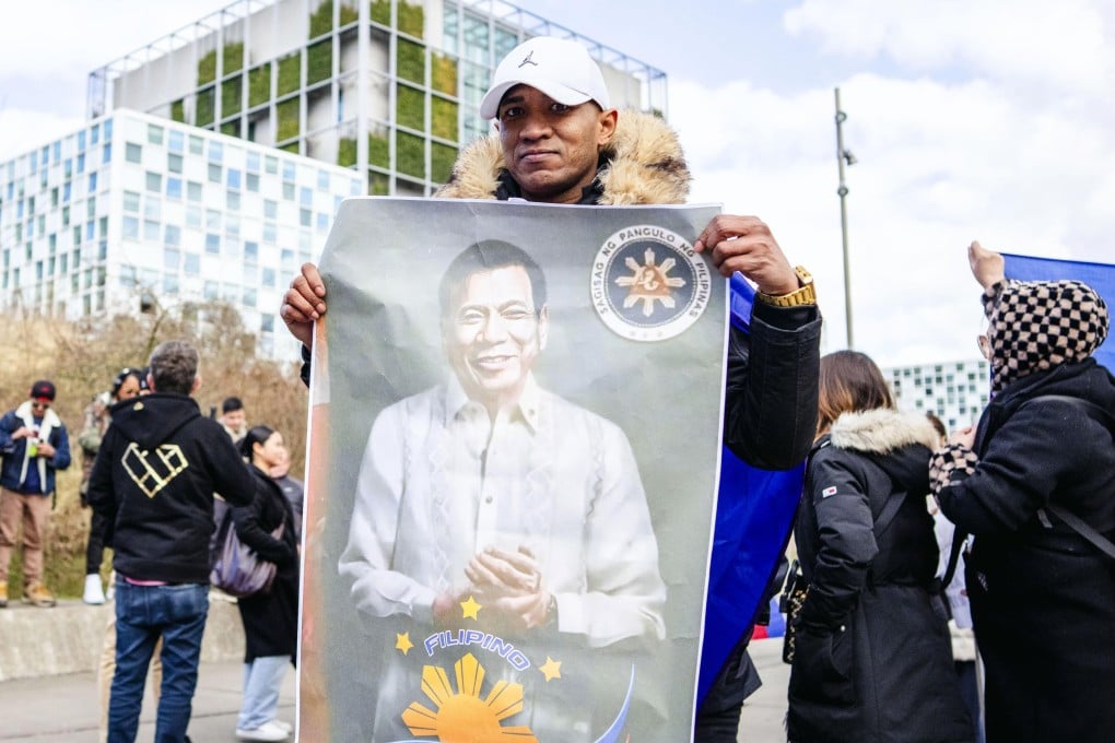 A supporter of former Philippine president Rodrigo Duterte displays his portrait as they gather in front of the International Criminal Court (ICC) in The Hague, The Netherlands, on March 14. Photo: EPA-EFE