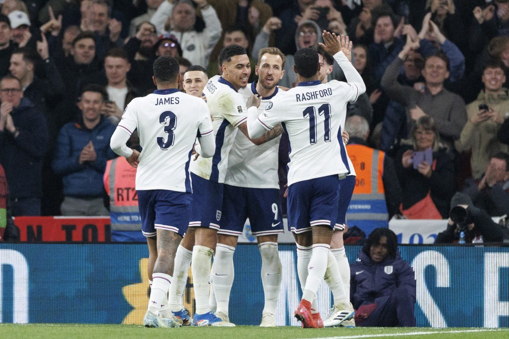 England captain Harry Kane celebrates with teammates Reece James, Phil Foden, Morgan Rogers, Marcus Rashford and Declan Rice after making it 2-0 against Latvia. Photo: EPA