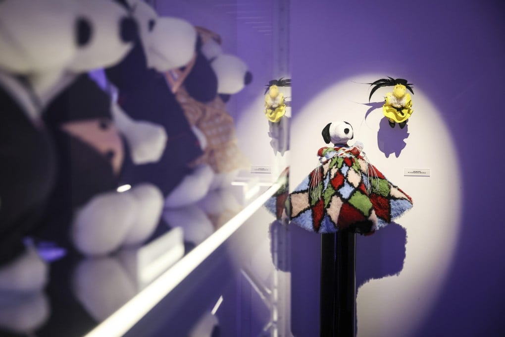 Figurines representing Snoopy wear creations at the Snoopy In Style exhibition in Paris. It showcases the beagle’s evolution into a fashion icon through designer collaborations. Photo: AP