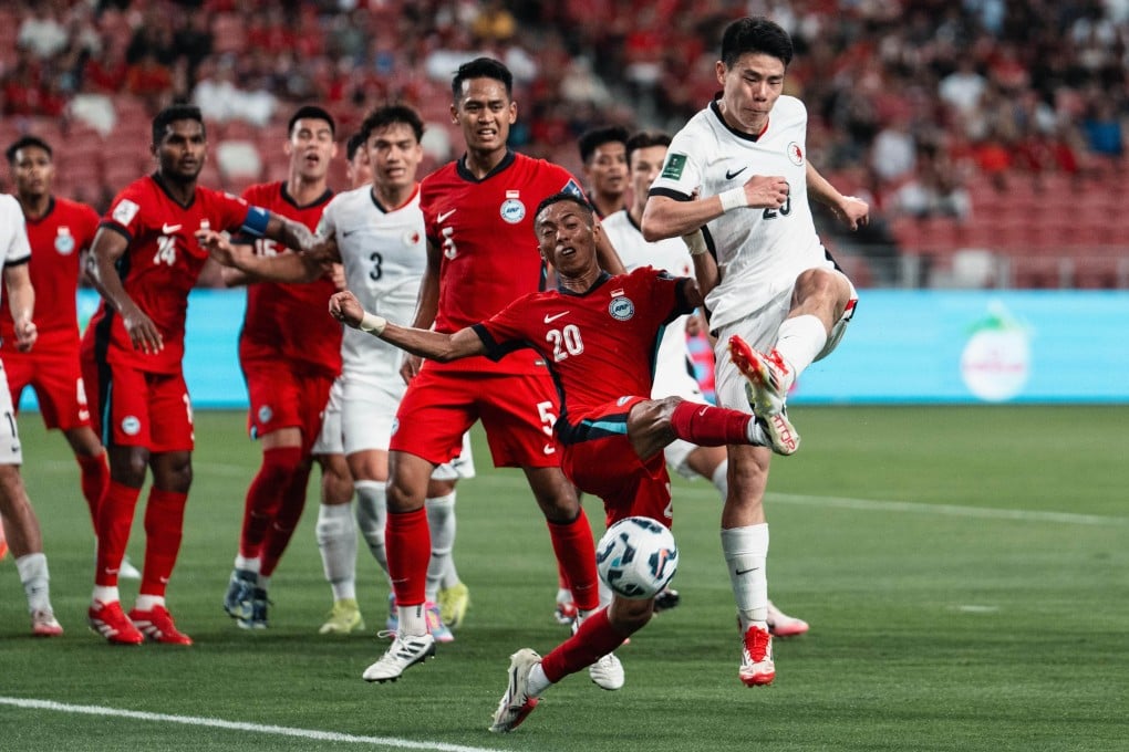 Sun Ming-him (right) turns the ball goalward under pressure from Singapore defender Shawal Anuar. Photo: HKFA