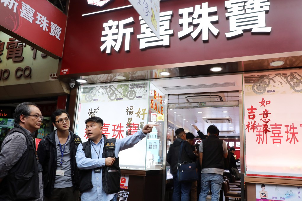 Police officers investigate the robbery at Sun Hai Jewellery store located on Kweilin Street in Sham Shui Po in March 2019. Photo: Sam Tsang
