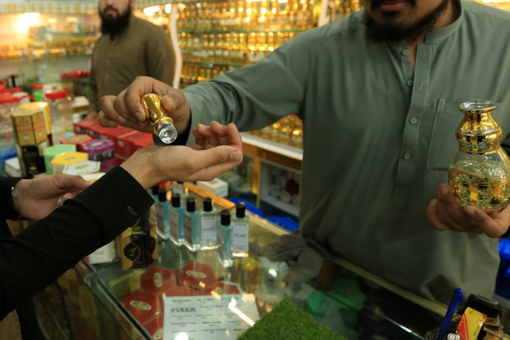 A customer tries on non-alcoholic perfumes at a shop in Peshawar, Pakistan, earlier this month. Photo: EPA-EFE