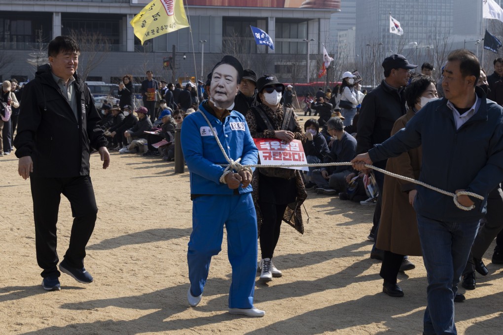 A protester wearing a mask of impeached South Korean president Yoon Suk-yeol at a rally in Seoulon Saturday. Photo: EPA-EFE