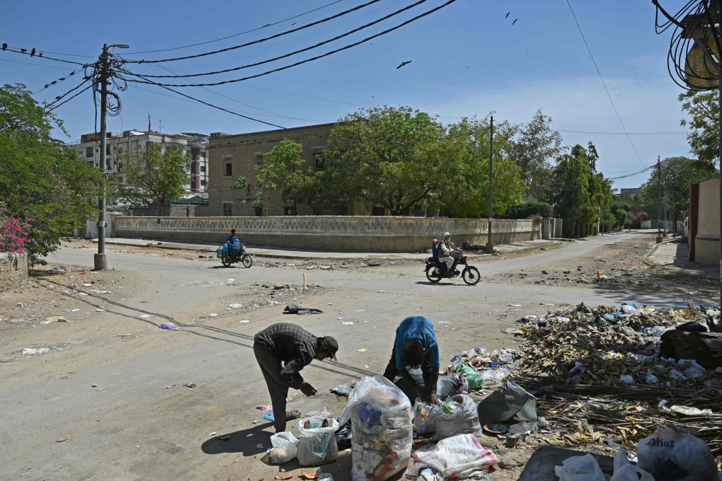 Garbage pickers sort waste strewn around the corner of the formerly clean and tidy Sohrab Katrak Parsi Colony, which was nearly deserted by its original inhabitants, in Karachi. Photo: AFP