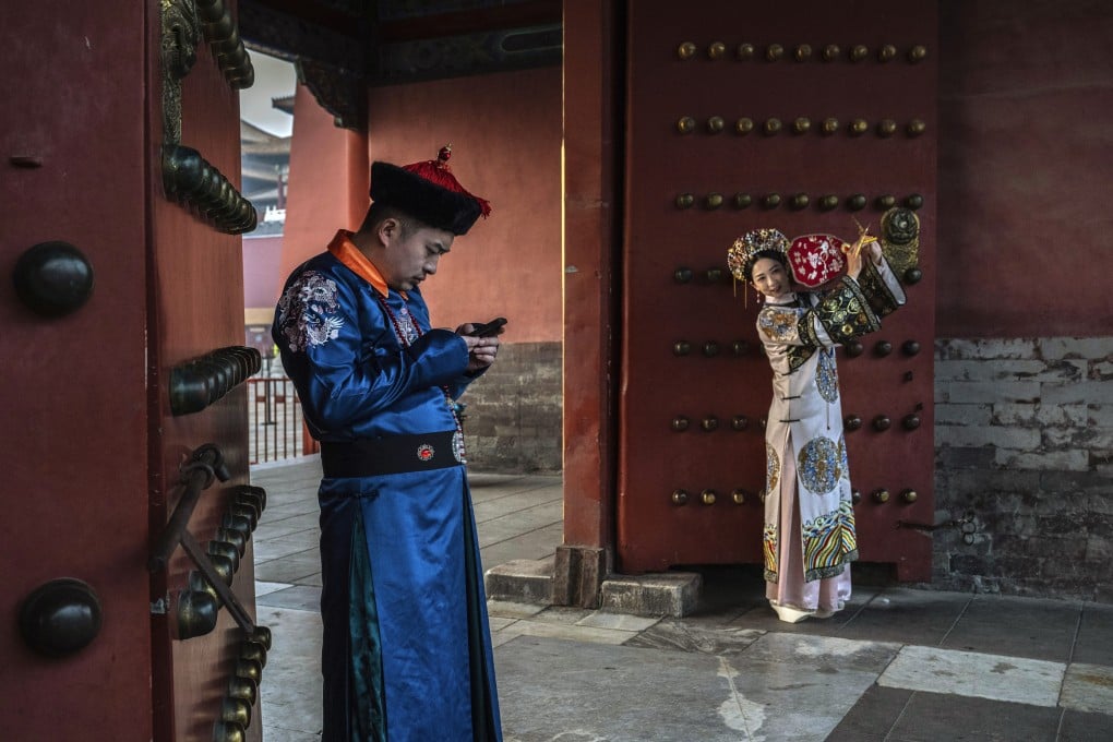 A man gets distracted by his phone while posing for wedding photos in Beijing. The surging popularity of China’s micro-dramas often keep people glued to their phones. Photo: Getty Images
