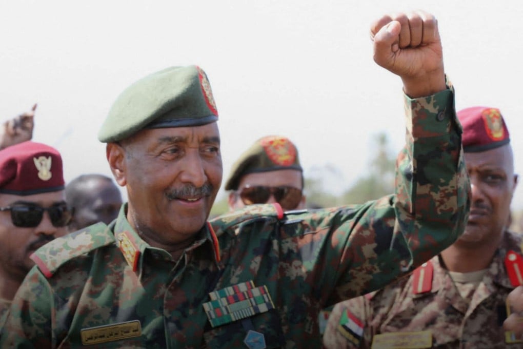 Sudan army chief Abdel Fattah al-Burhan gestures to soldiers inside the presidential palace on Wednesday. Photo: Sudan Transitional Sovereignty Council via Reuters