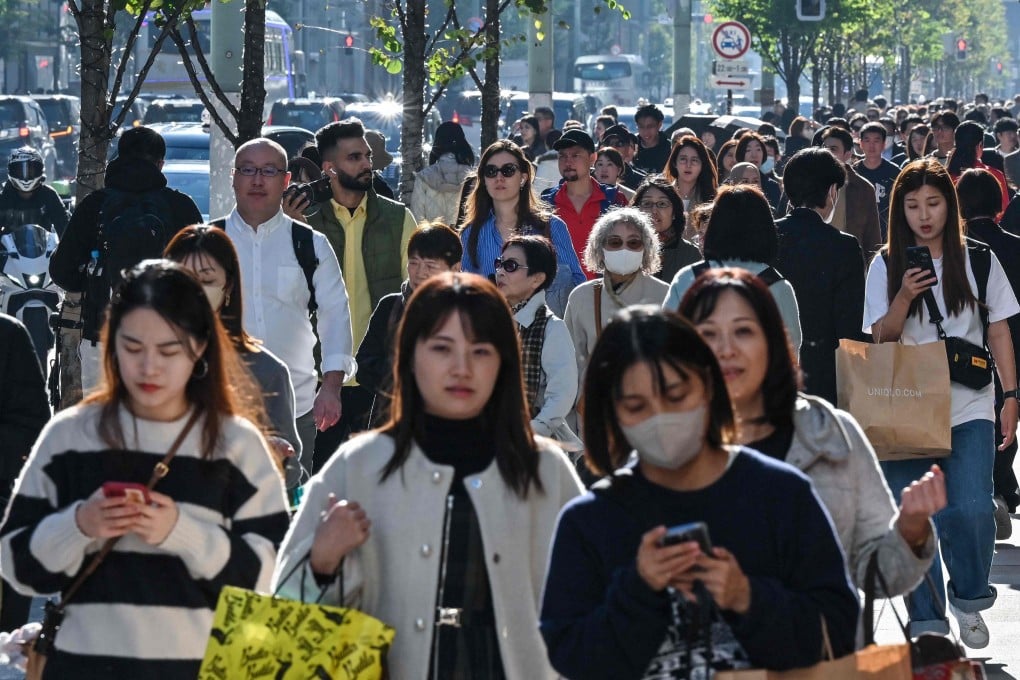 Pedestrians walk down a shopping area in Japan, which is dealing with a nationwide rise in cases of norovirus. Photo: AFP