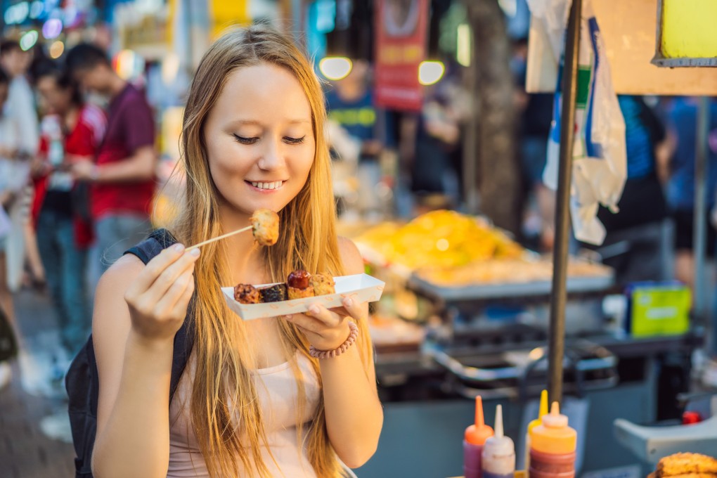 A young female solo traveller eats Korean street food in Seoul. The city was named the world’s No 1 destination for solo travellers in January by Tripadvisor, the world’s largest travel platform. Photo: Getty Images