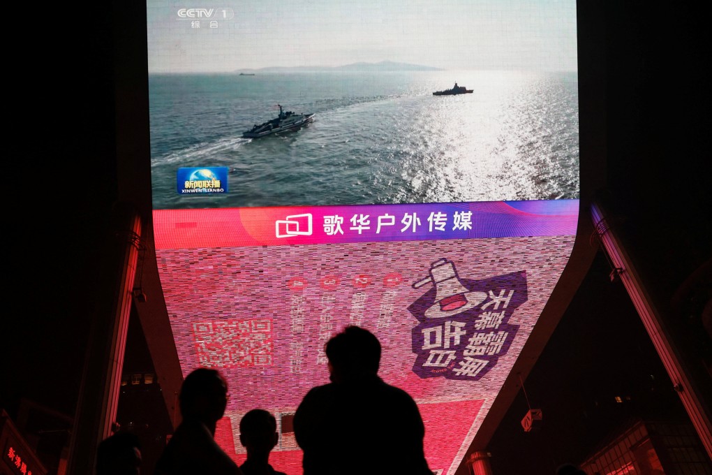 News footage of military drills conducted by the People’s Liberation Army in the Taiwan Strait are shown on screens in Beijing on October 14, 2024. Photo: Reuters