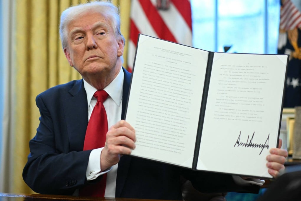 US President Donald Trump displays an executive order he signed announcing tariffs on auto imports at the White House in Washington, on March 26. Photo: AFP