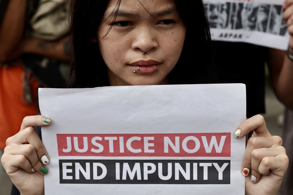 A supporter of victims of former Philippine president Rodrigo Duterte’s war on drugs holds a placard as she joins a demonstration in Manila, Philippines, on March 28, calling for the conviction of Duterte, who is currently under the custody of the ICC facing alleged crimes against humanity. Photo: EPA-EFE