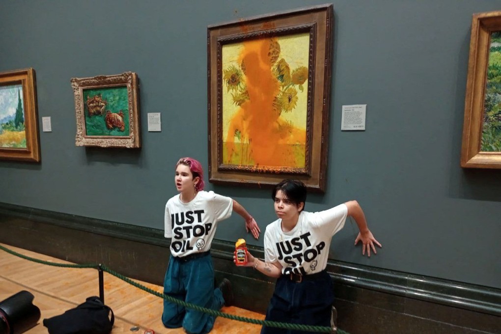 Just Stop Oil activists glue their hands to the wall after throwing soup at a van Gogh’s “Sunflowers” at the National Gallery in London in October 2022. Photo: Just Stop Oil via Reuters