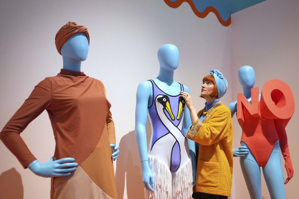 Guest curator Amber Butchart adjusts a swimsuit on display in Splash! A century of Swimming and Style, an exhibition of swimwear and swim-related items at The Design Museum in London. Photo: AP