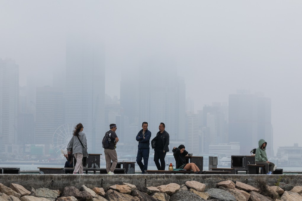 People take a walk amid foggy weather near Victoria Harbour. Photo: Dickson Lee