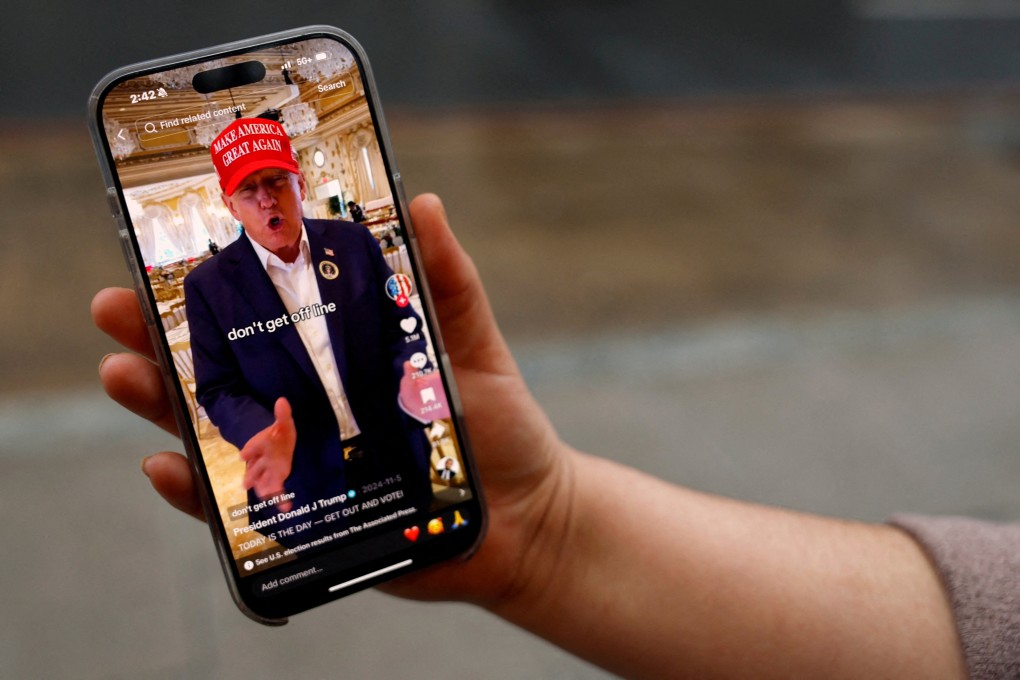 A woman poses with her smartphone displaying the @realdonaldtrump TikTok page, in Washington in January 2025. Photo: Reuters