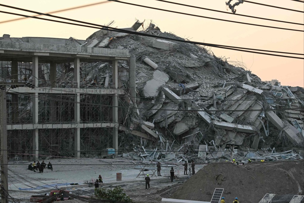 Emergency services crew survey the site of a collapsed building in Bangkok which collapsed in the tremors caused by a 7.7 magnitude earthquake in neighbouring Myanmar. Photo: AFP