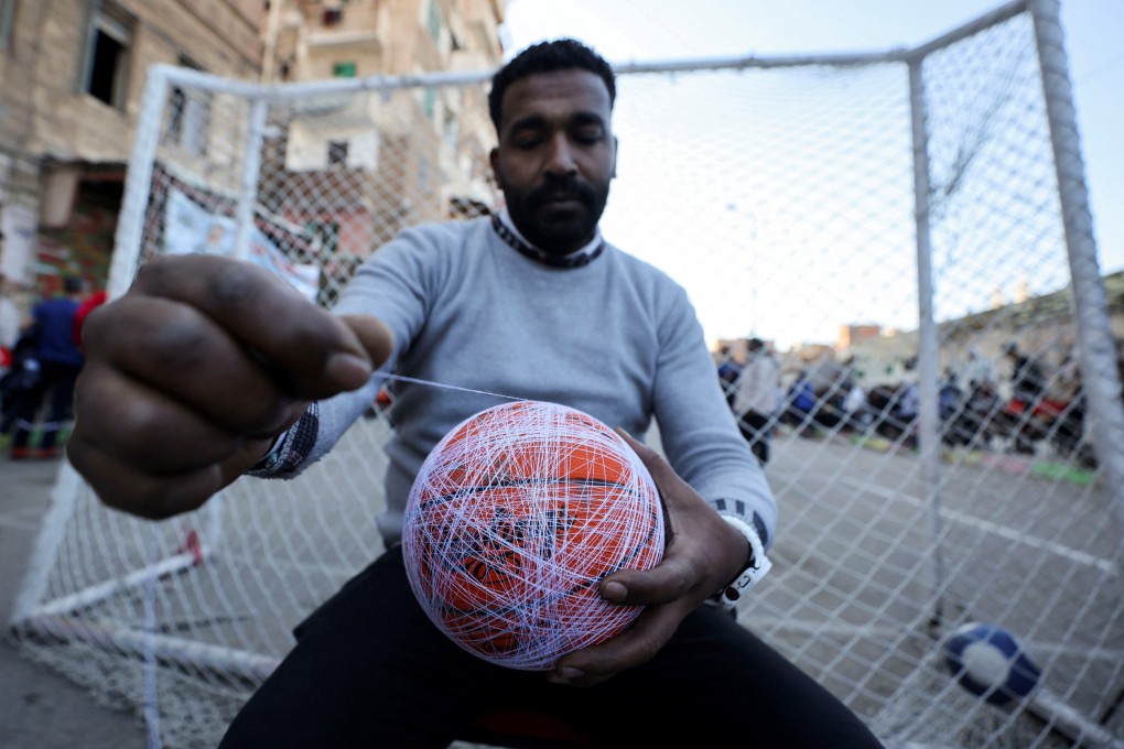 Essam Bakkar prepares the ball on the day of a sock ball match on a street in Alexandria, Egypt, on March 23, 2025. Photo: Reuters