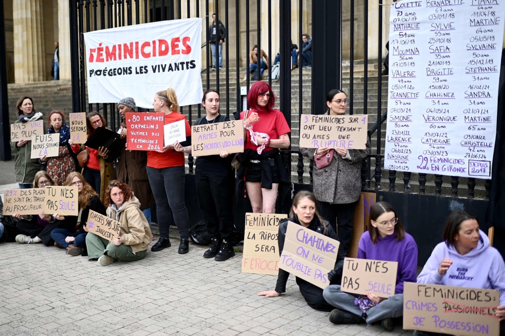 Protestors hold signs in front of a banner reading “Femicides, let’s protect the living” on the sidelines of the trial of Chahinez Daoud’s husband on Monday. Photo: AFP