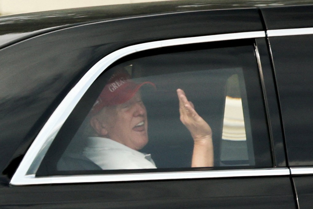 US President Donald Trump waves to supporters as he leaves his golf course in West Palm Beach, Florida, on Saturday. Photo: Reuters