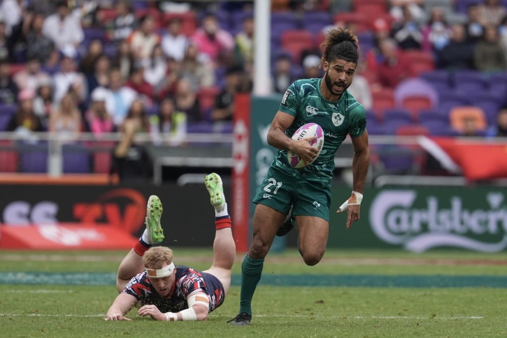 Ireland’s Josh Costello runs out of a tackle by Great Britain’s Sunni Jardine on day three of the Hong Kong Sevens. Photo: Elson Li